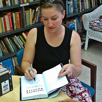 Rhiannon Meyers signs a copy of Infinte Monster.